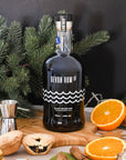 Devon Rum Co Black Spiced Rum in a festive setting with mince pies and orange slices.