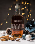 Devon Rum Co Premium Spiced Rum with baubles and festive setting.