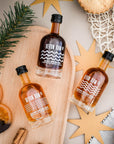 Devon Rum bottles on a wooden board with festive decorations