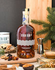Devon Rum Co Premium Golden Rum in a festive setting with mince pies and dried fruits.