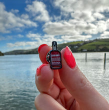 Load image into Gallery viewer, Small Enamel Devon Rum Co Spiced Rum Bottle Pin Over the Water in Salcombe
