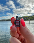 Small Enamel Devon Rum Co Spiced Rum Bottle Pin Over the Water in Salcombe