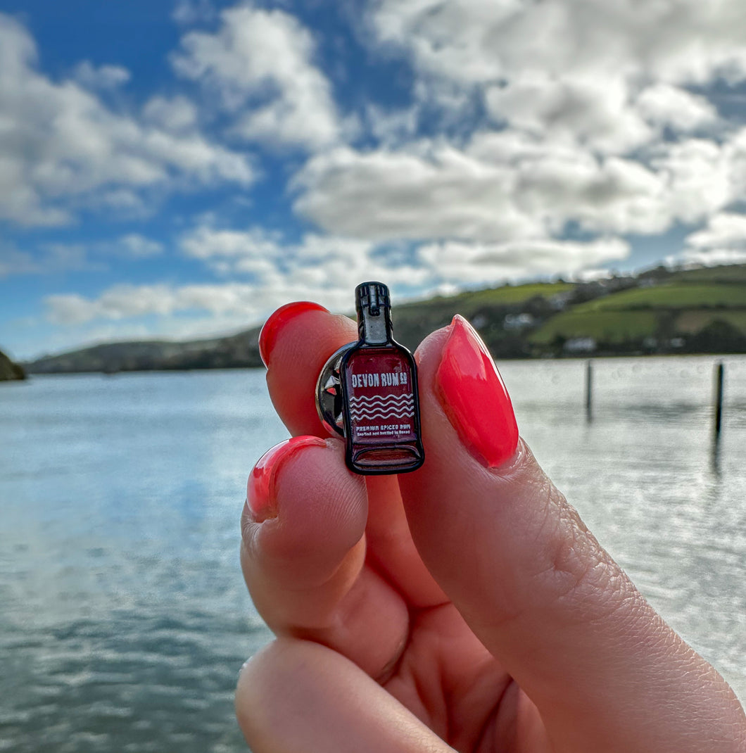 Small Enamel Devon Rum Co Spiced Rum Bottle Pin Over the Water in Salcombe