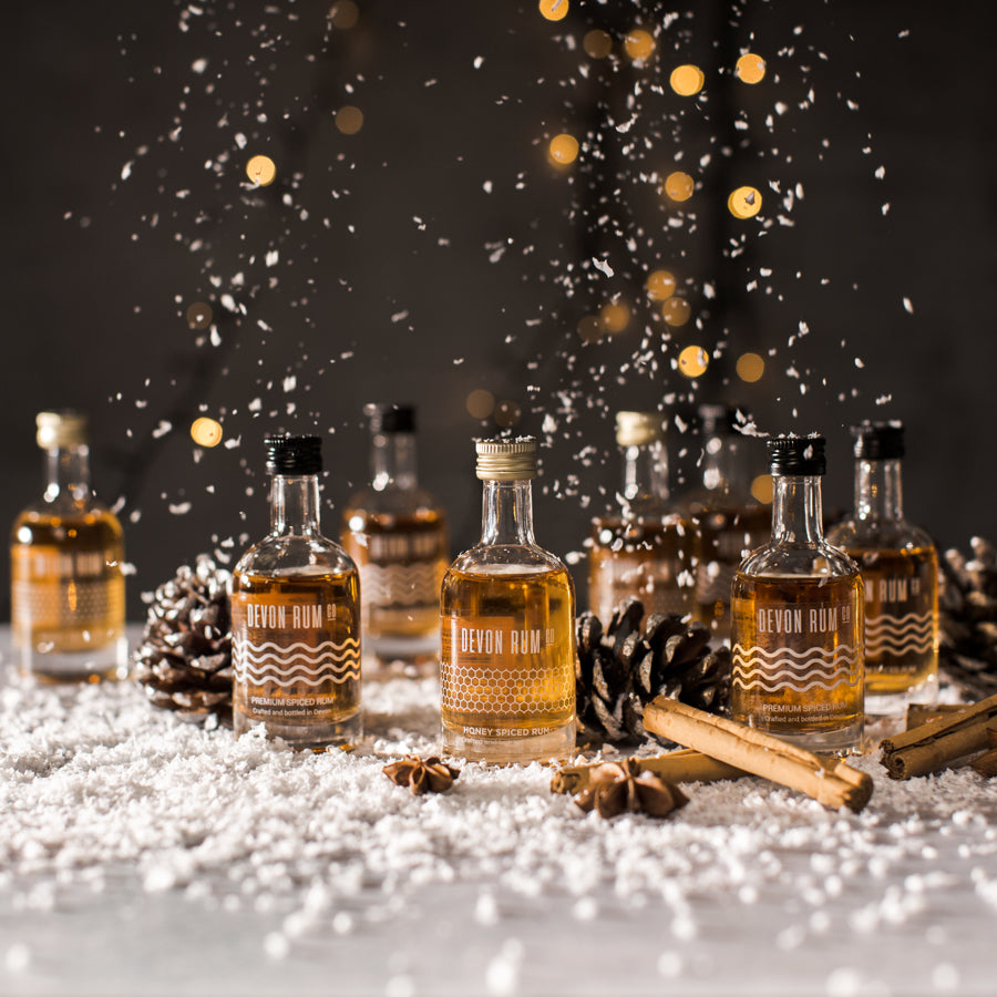 Devon Rum Co Miniatures in a festive scene with snow falling.