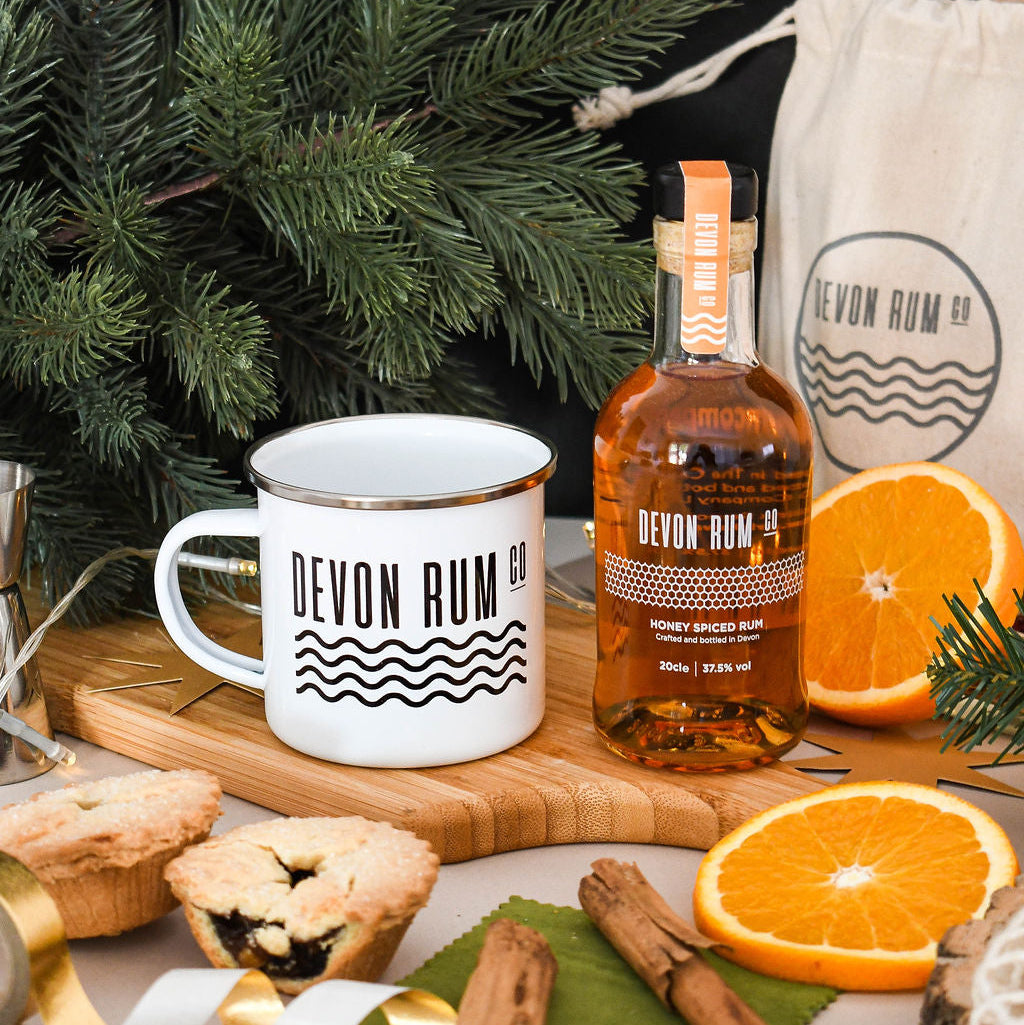 Devon Rum Co Enamel Mug and Honey Spiced Rum with a festive setting.