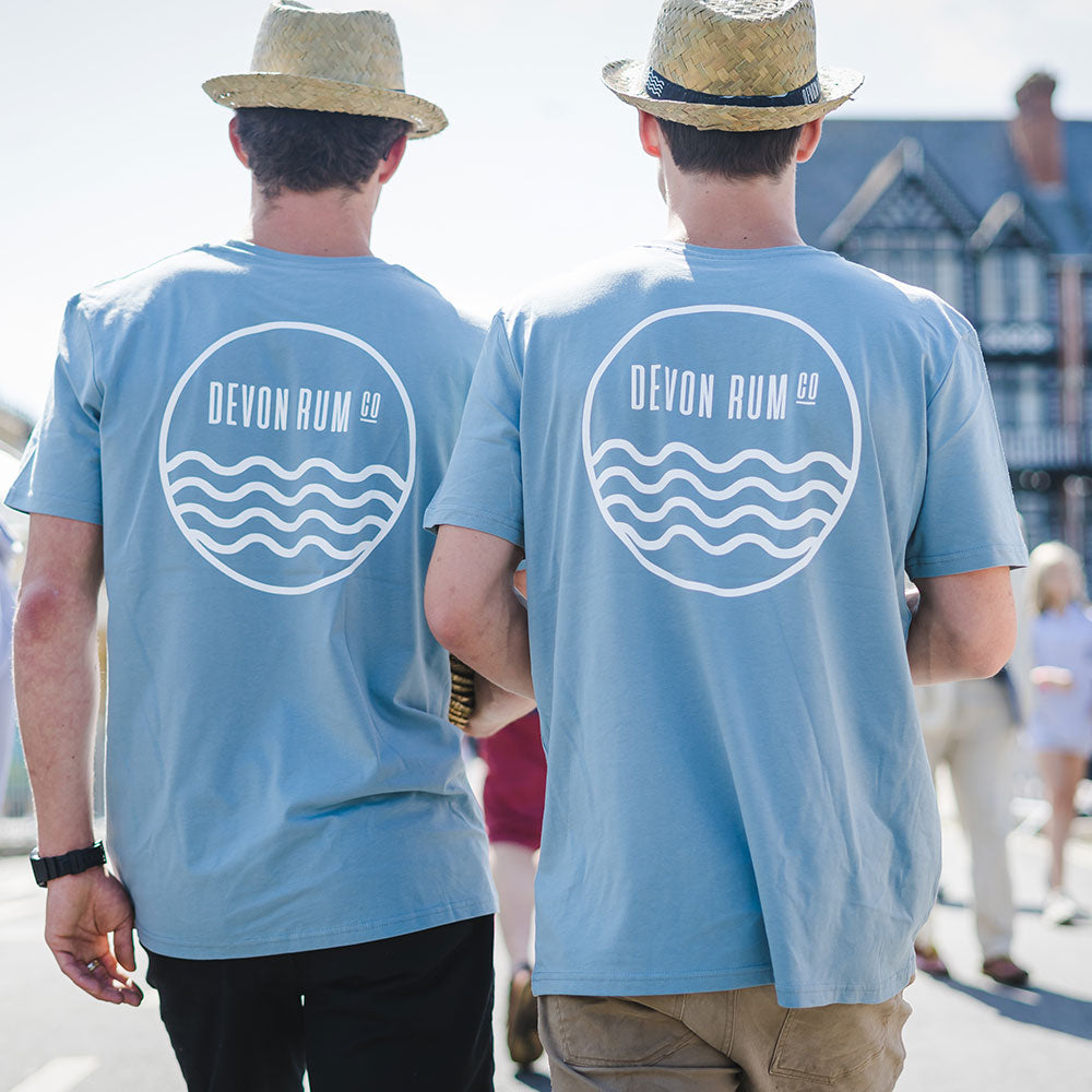 Two men wearing blue fitted organic cotton t-shirts by the Devon Rum Company